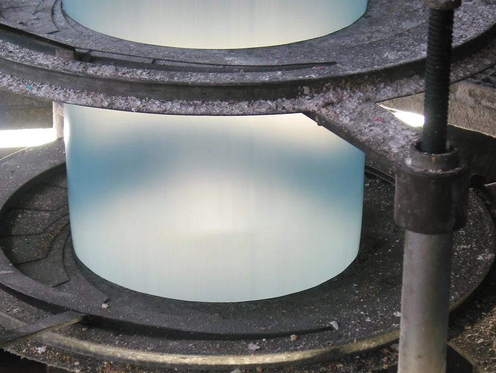 Close view of a plastic-film bubble passing through a blown-film extrusion setup